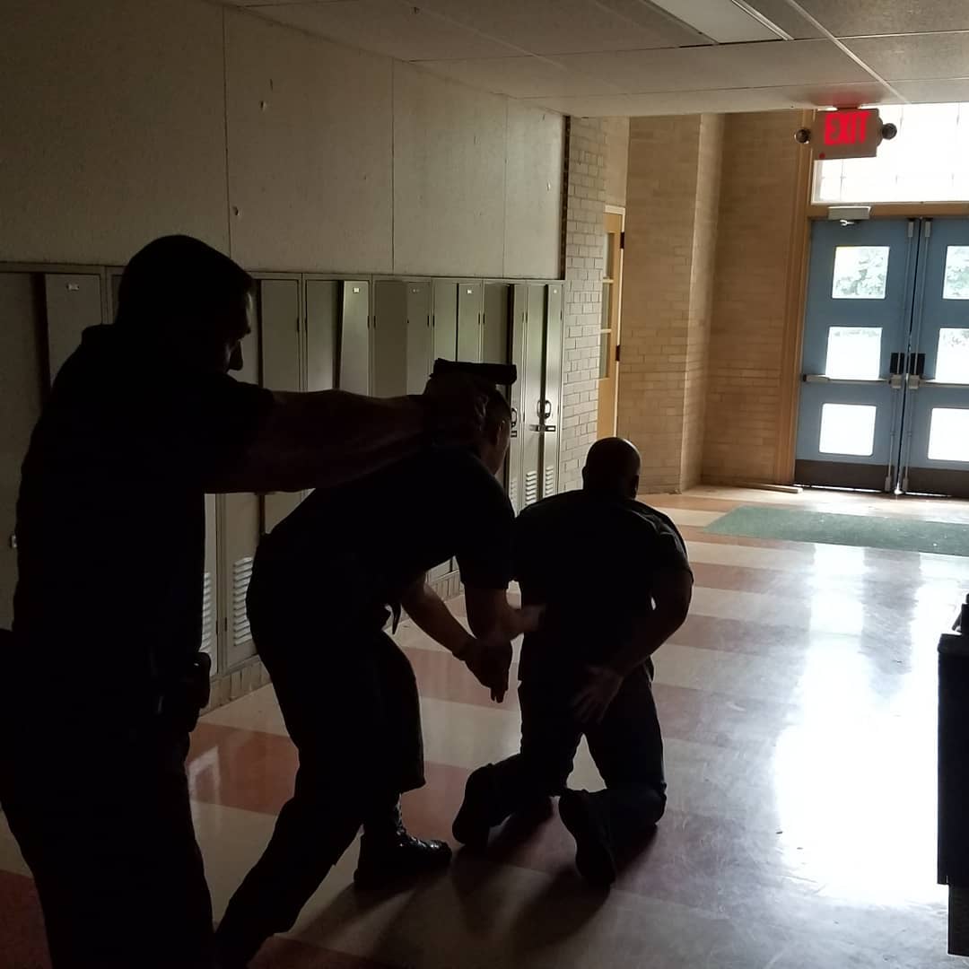 Men in front of the door practicing a hostage situation